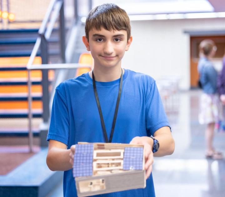 A FITE camper displays his project